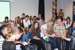 The audience listens attentively